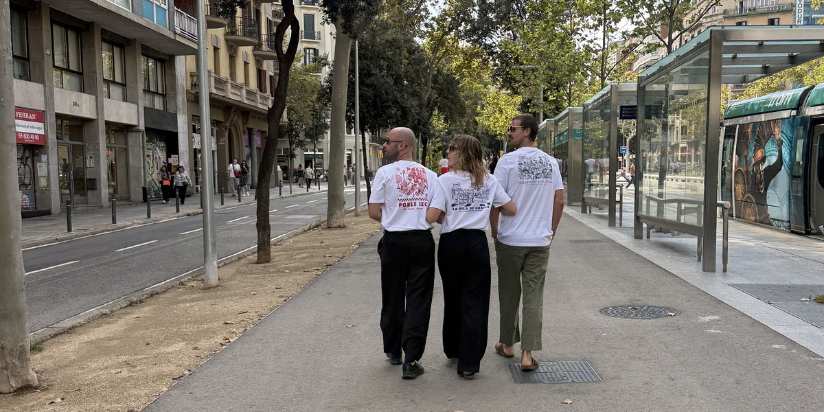 Three friends walking through Barcelona wearing Patxoca neighbourhood T-shirts.